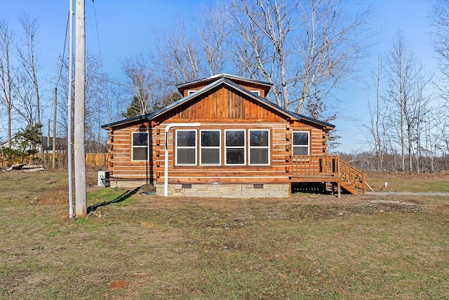 back of house featuring crawl space, a lawn, a deck, and log exterior