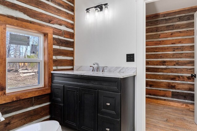 kitchen with a healthy amount of sunlight, light countertops, a sink, and hanging light fixtures