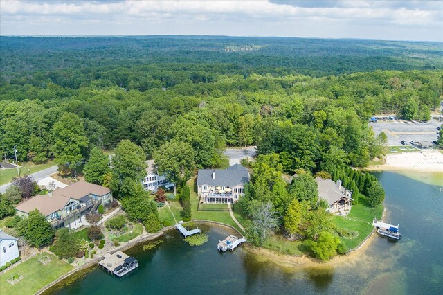 aerial view featuring a water view and a forest view