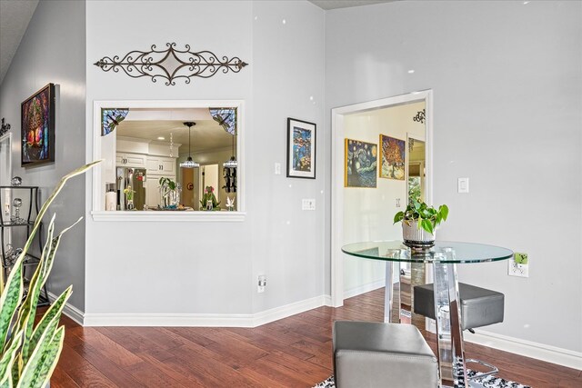 interior space with baseboards and wood finished floors