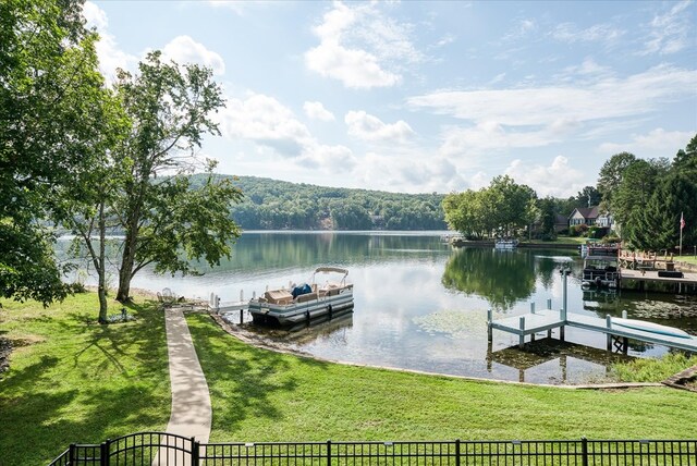 dock area featuring a water view and a yard