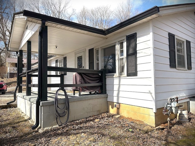 view of side of property with covered porch