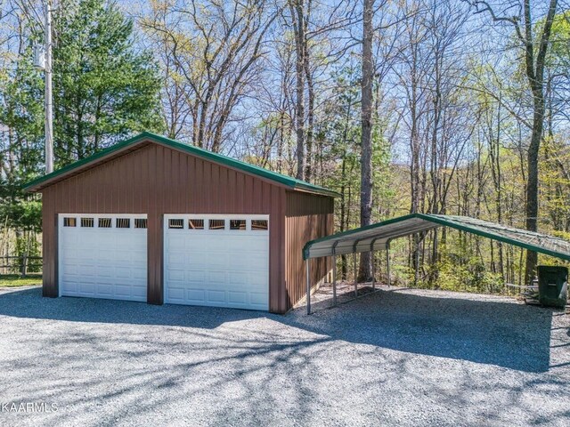 detached garage featuring a carport