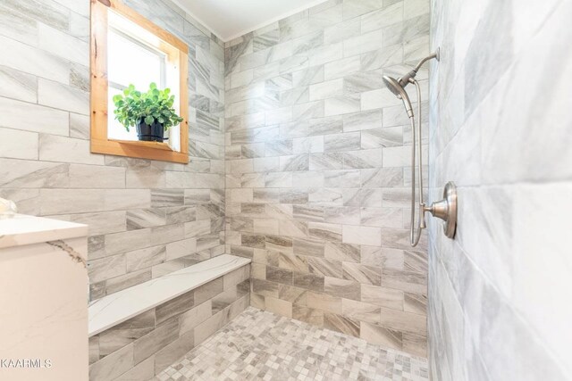 full bath featuring tiled shower