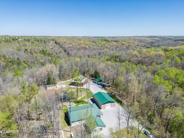 drone / aerial view with a wooded view