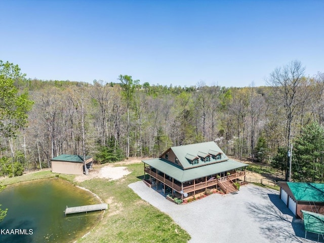 drone / aerial view with a water view and a view of trees