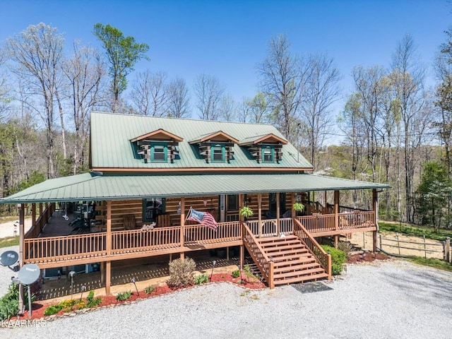 log-style house featuring stairs, metal roof, a porch, and log exterior