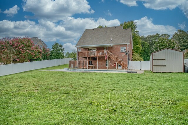 rear view of house with a patio, a fenced backyard, stairway, a shed, and brick siding