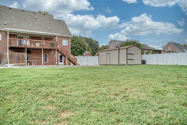 view of yard with a shed, stairway, an outdoor structure, and a fenced backyard