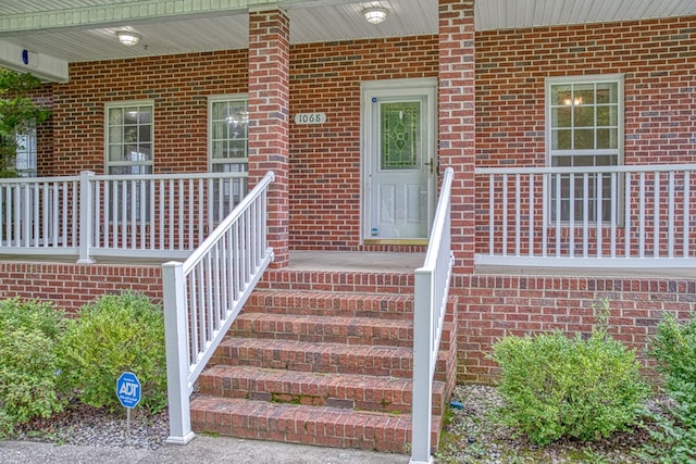 property entrance featuring brick siding