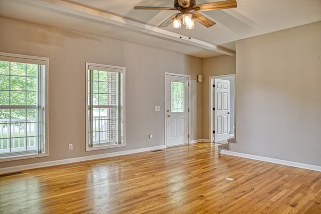 interior space with light wood-style floors, visible vents, baseboards, and a ceiling fan