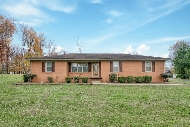 ranch-style house featuring brick siding and a front lawn