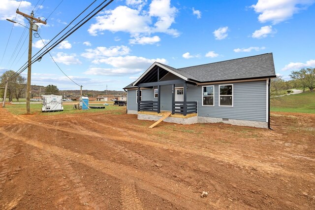 view of front of property with crawl space and a shingled roof