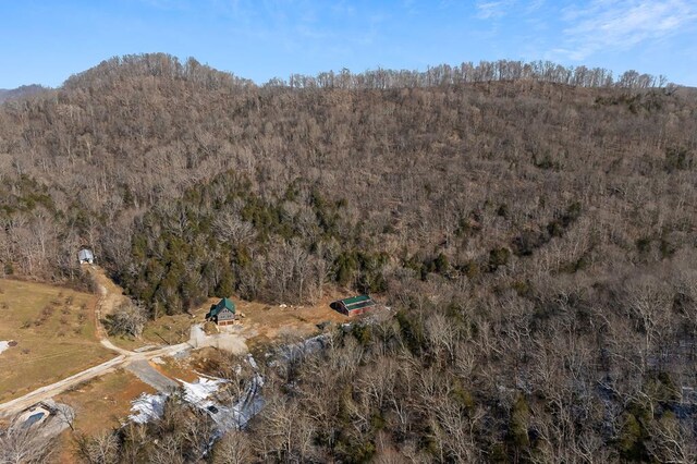 drone / aerial view featuring a wooded view