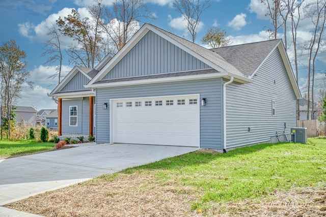 view of front facade featuring a garage, driveway, a front lawn, and cooling unit