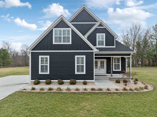 view of front of home with french doors, a front lawn, roof with shingles, and a porch