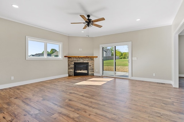 unfurnished living room with a wealth of natural light, a fireplace, and wood finished floors