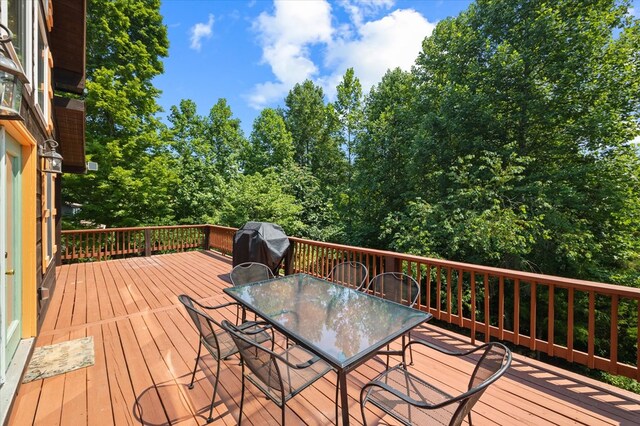 deck with grilling area and outdoor dining space