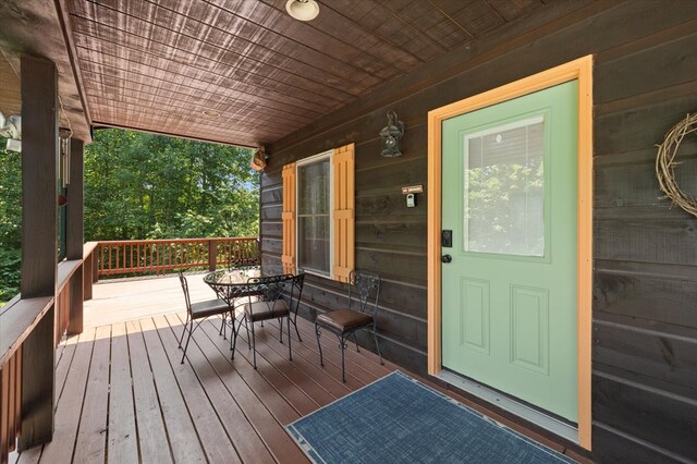 wooden terrace with outdoor dining area