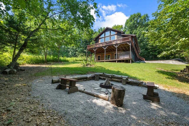 rear view of property with a yard, a patio, and a wooden deck