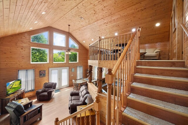 living room with high vaulted ceiling, french doors, wooden ceiling, and stairway