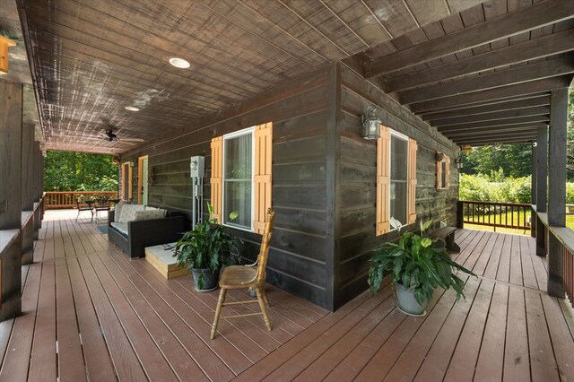 wooden terrace with outdoor lounge area and ceiling fan