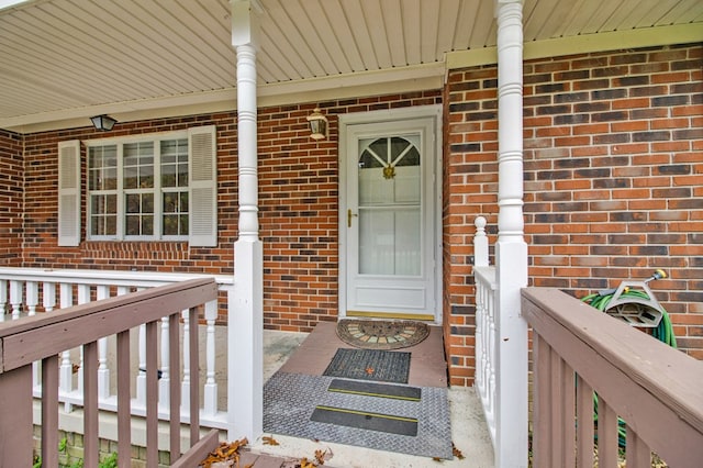 view of exterior entry featuring brick siding