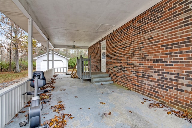 view of patio featuring a ceiling fan, an outbuilding, and a detached garage