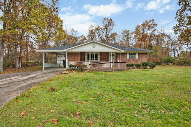 ranch-style house with a carport, brick siding, driveway, and a front lawn