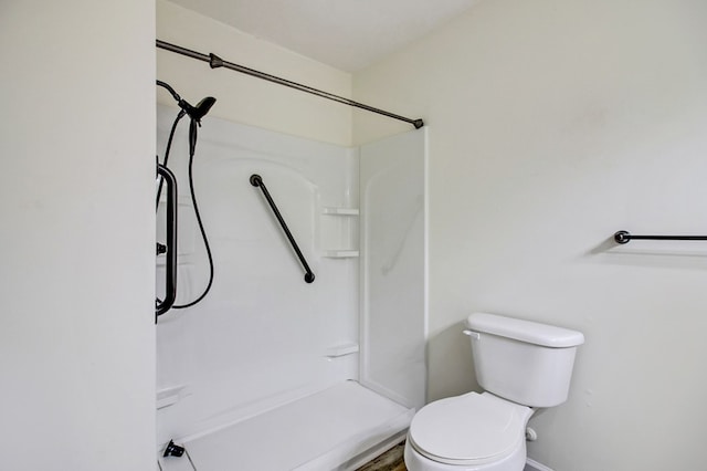 bathroom with toilet and walk in shower