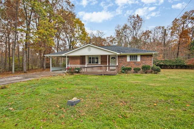 view of front of property featuring a porch, brick siding, driveway, and a front lawn