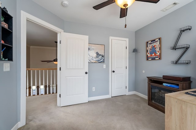 office area featuring visible vents, carpet floors, baseboards, and a ceiling fan