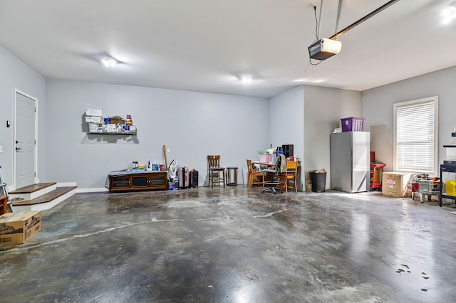 garage with a garage door opener and freestanding refrigerator