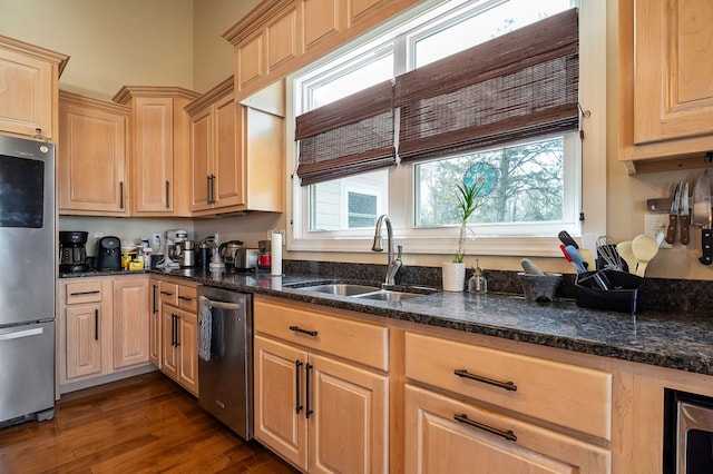 kitchen featuring a sink, stainless steel appliances, dark wood-style floors, and light brown cabinetry