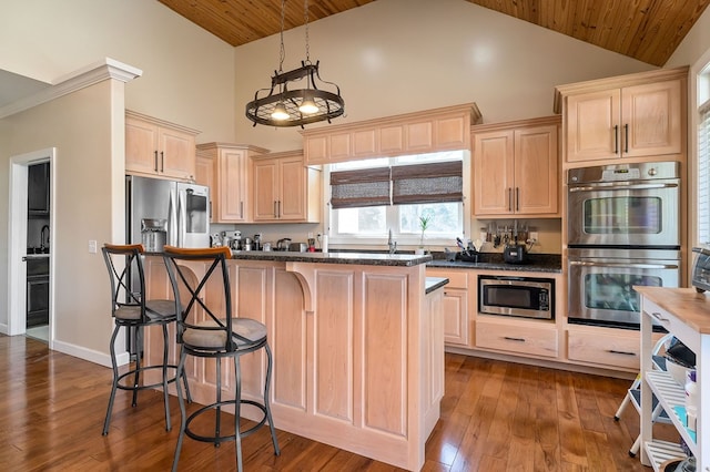 kitchen featuring high vaulted ceiling, light brown cabinets, a kitchen island, dark wood-style floors, and stainless steel appliances