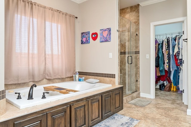 bathroom with a walk in closet, a garden tub, a stall shower, and tile patterned flooring