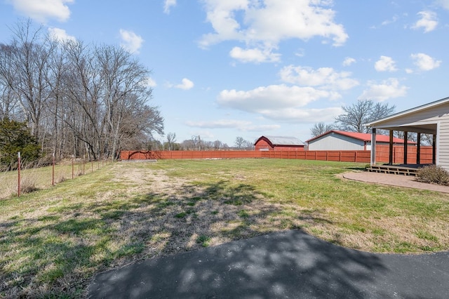 view of yard featuring a rural view, a patio area, and fence private yard