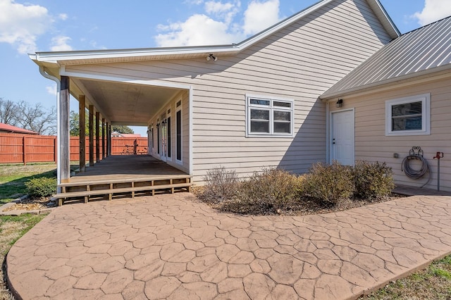 view of patio featuring fence and a wooden deck