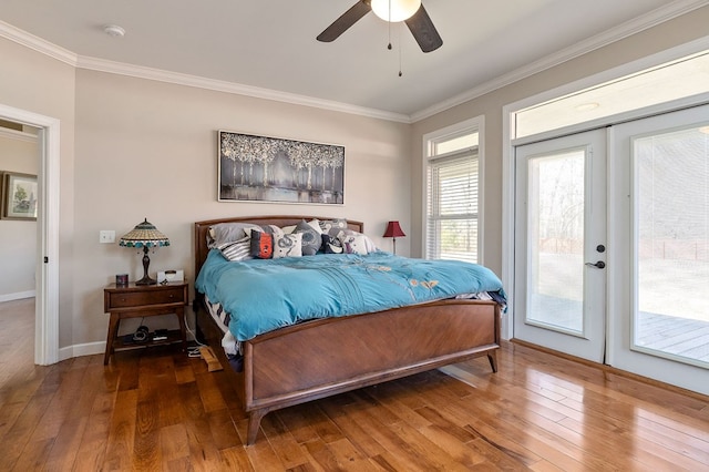 bedroom with access to exterior, hardwood / wood-style floors, and ornamental molding