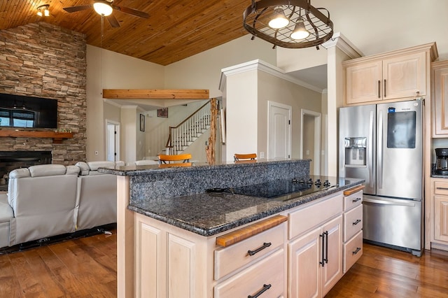 kitchen featuring dark wood finished floors, ceiling fan, stainless steel fridge, wooden ceiling, and open floor plan