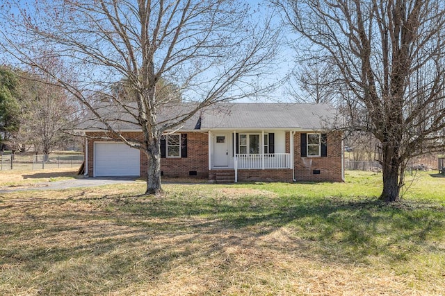 ranch-style home with fence, an attached garage, a front lawn, crawl space, and brick siding