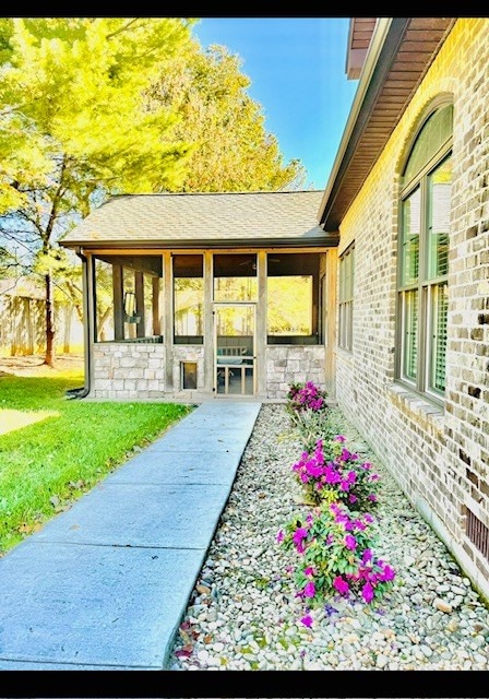 exterior space featuring brick siding and a lawn