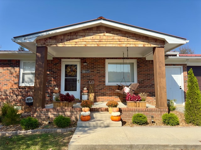 view of front of house featuring covered porch and brick siding