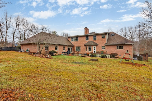 back of property featuring a patio, brick siding, fence, a lawn, and a chimney