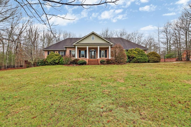 neoclassical home with covered porch and a front yard