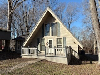 rear view of house featuring covered porch