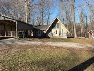 exterior space featuring driveway and a detached carport