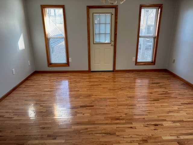 interior space with light wood-style floors and baseboards