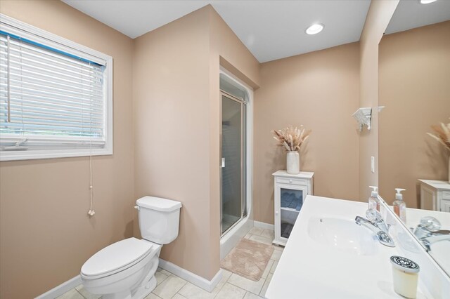 bathroom featuring a stall shower, baseboards, toilet, tile patterned flooring, and vanity