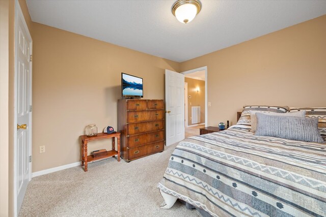 bedroom with visible vents, baseboards, and light colored carpet